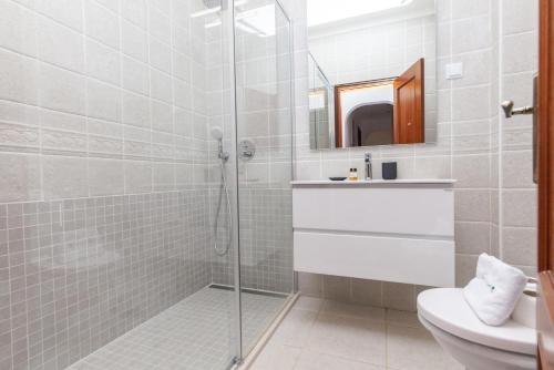 a bathroom with a shower and a toilet and a sink at A49 - Anastasia Apartment in Lagos in Lagos