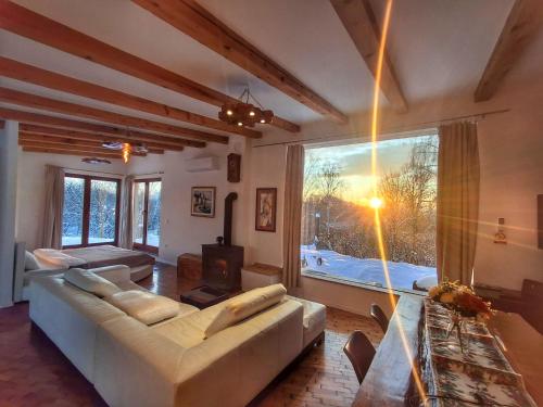 a living room with a white couch and a large window at Svetli Raj in Pregrada