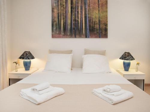 a bedroom with a bed with two towels on it at Apartment Alpes et Lac 28 by Interhome in Champex