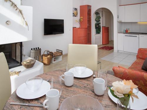 a dining room table with white dishes on it at Apartment Alpes et Lac 28 by Interhome in Champex