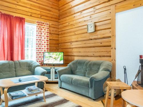 a living room with two couches and a tv at Holiday Home Kranni 1 by Interhome in Syöte
