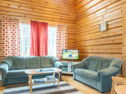 a living room with two couches and a tv at Holiday Home Kranni 1 by Interhome in Syöte