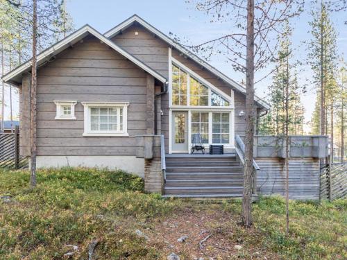 a small house with a porch and stairs in front at Holiday Home Otso by Interhome in Pyhätunturi