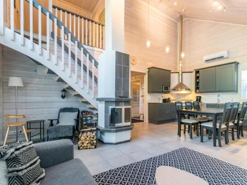 a kitchen and living room with a staircase and a table at Holiday Home Otso by Interhome in Pyhätunturi