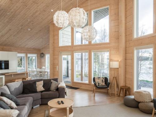 a living room with a couch and a table at Holiday Home Leinola by Interhome in Sotkamo