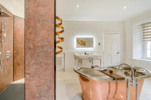 a bathroom with a copper tub and a sink at 4 Bed in Armathwaite oc-e34641 in Armathwaite