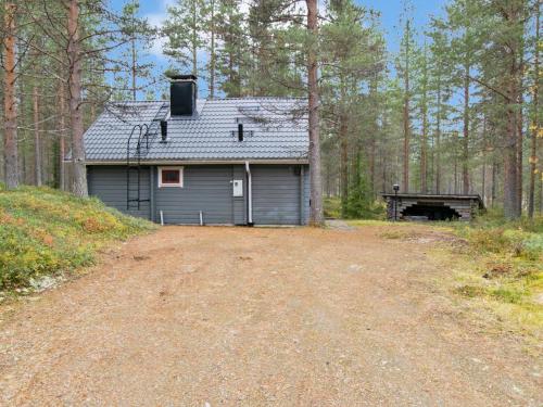 a garage in the woods next to a dirt road at Holiday Home Pikku pyhis by Interhome in Pyhätunturi