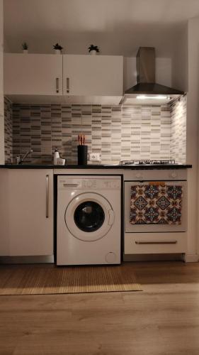 a kitchen with a washing machine in a kitchen at Ro'& Ro' in Montemarciano