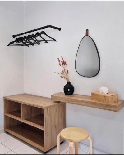 a room with a shelf and a mirror and a stool at Αγριελια Apartments in Platy