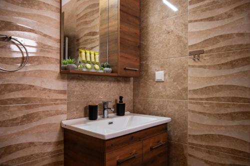 a bathroom with a sink and a mirror at ΠΟΛΥΤΕΛΕΣ -ΜΟΝΤΕΡΝΟ ΔΙΑΜΕΡΙΣΜΑ in Larisa