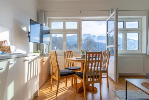 a kitchen and dining room with a table and chairs at Villa Weber Apartments in Albrechtice v Jizerských horách