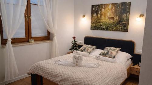a bedroom with a bed with a christmas tree on it at Agroturystyka Serce Łysicy in Święta Katarzyna