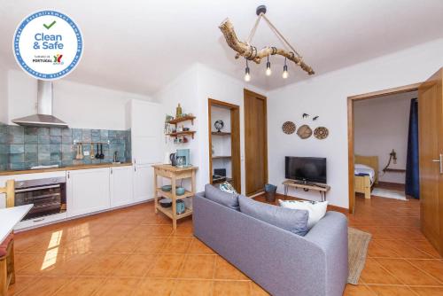 a living room with a couch and a tv at A56 - Westway Rossio Holiday Place in Luz