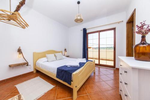 a bedroom with a bed and a large window at A56 - Westway Rossio Holiday Place in Luz
