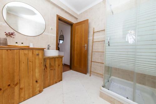 a bathroom with a shower and a sink and a mirror at A56 - Westway Rossio Holiday Place in Luz