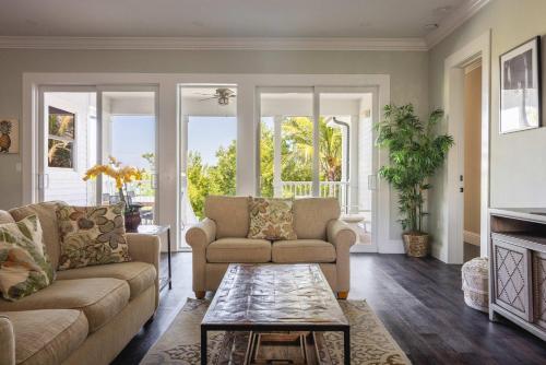 a living room with two couches and a coffee table at Capmar House -Huge Home & Pool in Stock Island