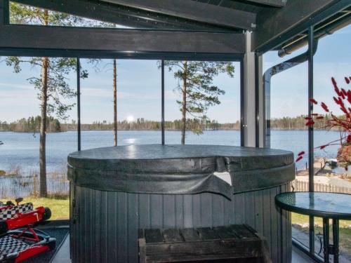 a large outdoor grill with a view of a lake at Holiday Home Metsäpirtti by Interhome in Keuruu