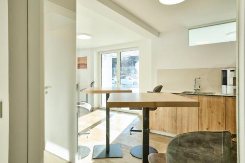 a kitchen and dining room with a table and chairs at Starnberger See Apartments in Starnberg