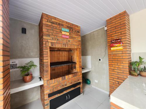 a brick wall in a room with plants at La Calma San Bernardino in San Bernardino