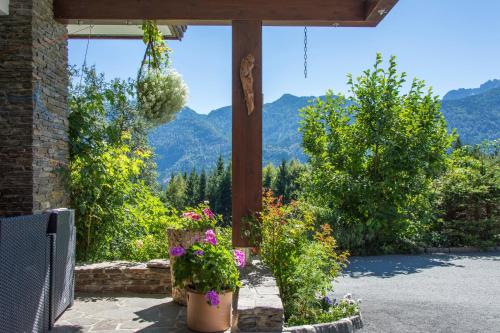 a porch with flowers and a view of mountains at Ferienhaus Waldhof in Hermagor