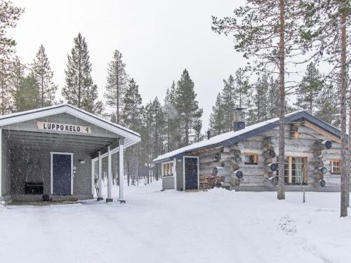 a log cabin in the woods in the snow at Holiday Home Luppokelo by Interhome in Saariselka