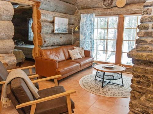 a living room with a leather couch and a table at Holiday Home Luppokelo by Interhome in Saariselka