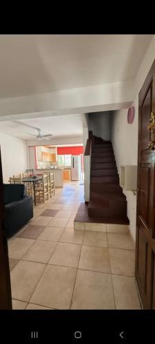 a living room with a staircase and a dining room at Bela house in Concepción del Uruguay