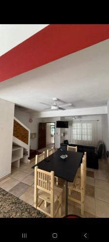 a living room with a black table and chairs at Bela house in Concepción del Uruguay