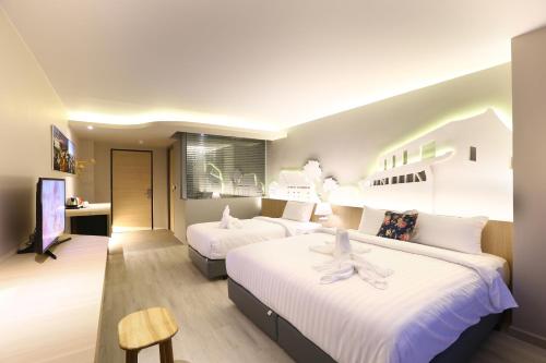 Ένα ή περισσότερα κρεβάτια σε δωμάτιο στο Hatyai Signature Hotel