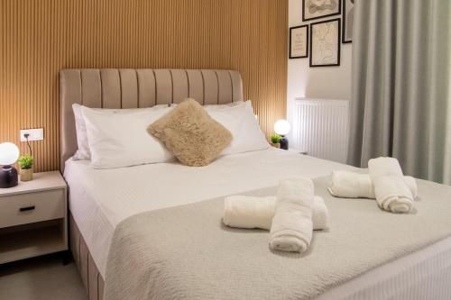 a bedroom with a bed with towels on it at Ophelia's - Luxury Apartment in Volos
