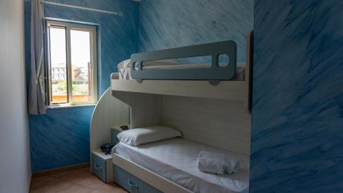a small room with two bunk beds and a window at Teresan Homestay in Mascali