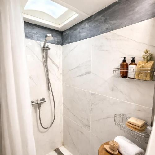 a shower in a bathroom with white marble at Social Distanсing Approved Nature Getaway! in Naples