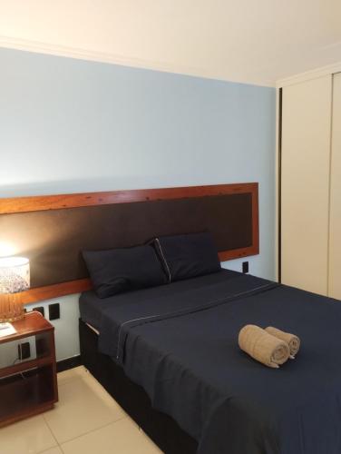 a bedroom with a bed with a wooden head board at Eco paradise 134 in Cumbuco