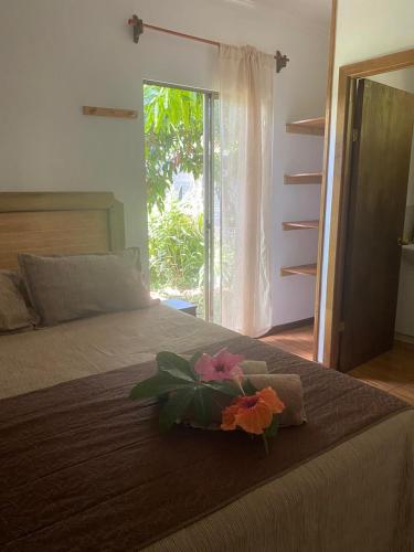 a bed with a flower on top of it at Pumakari Rapa Nui in Hanga Roa