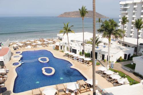 an aerial view of a resort with a pool and the ocean at Sunvivia by Fiesta Americana Mazatlán in Mazatlán