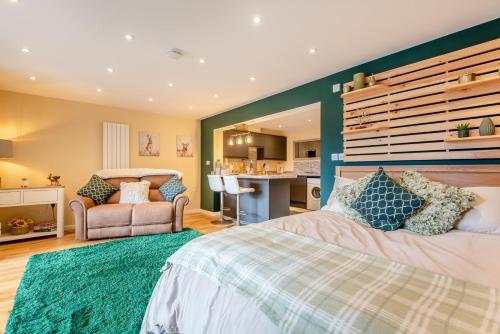 a bedroom with a bed and a chair and a kitchen at 1 Bed in Far Forest oc-d30808 in Rock