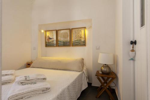 a bedroom with a bed with towels on it at A27 - Caracol Corner Studio in Lagos in Lagos
