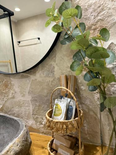 a bathroom with a sink and a mirror and a plant at addview 2 in Nafplio