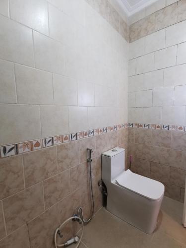 a bathroom with a white toilet in a room at Jubeiha Home in Amman