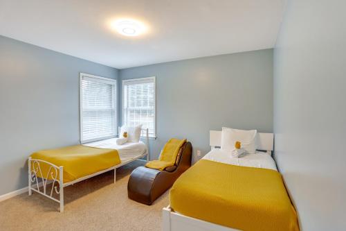 a bedroom with a yellow bed and a chair at Game Room and Covered Patio Hummelstown Hideaway in Hummelstown