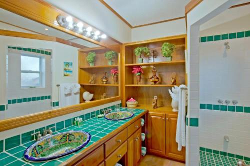 a bathroom with two sinks and a large mirror at Belizean Dreams Resort in Hopkins