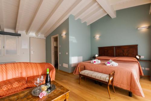 a bedroom with two beds and a couch at Il Bagnolo Eco Lodge in Salò