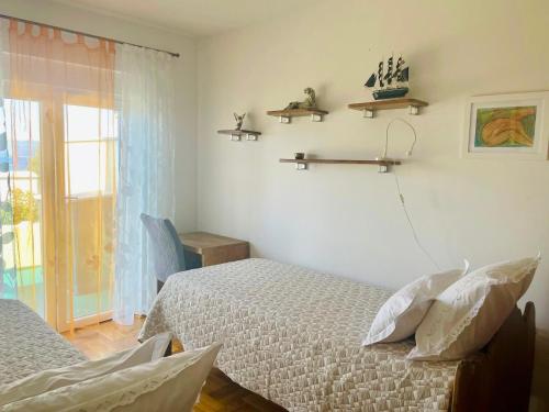 a bedroom with two beds and a window at Apartment Mandarina in Dugi Rat