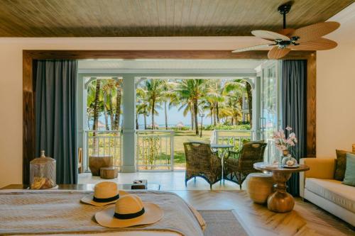 a living room with a bed with hats on it at The St. Regis Le Morne Resort, Mauritius in Le Morne