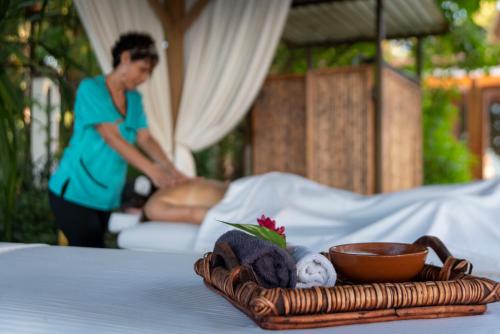 a tray of towels and a bowl on a table at Capitán Suizo Beachfront Boutique Hotel in Tamarindo