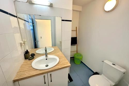 a bathroom with a sink and a toilet and a mirror at Ti Turtle in Saint-François