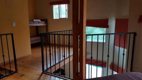 a view of a room with a staircase in a house at Los Aromos Cabañas loft in San Marcos Sierras