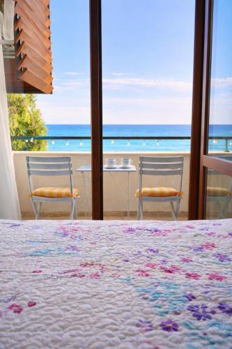 a bedroom with a bed and a view of the ocean at Apartment Sea Sunrise, complex Carpe Diem, FREE PARKING in Balchik