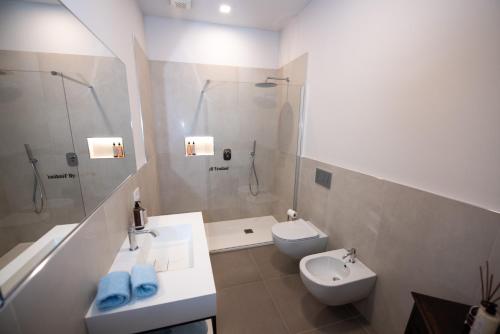 a bathroom with a sink and a toilet and a shower at Al Ventisei - Azzurro in Treiso