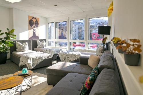 a living room with a couch and a table at Schlossberg Residence in Freiburg im Breisgau